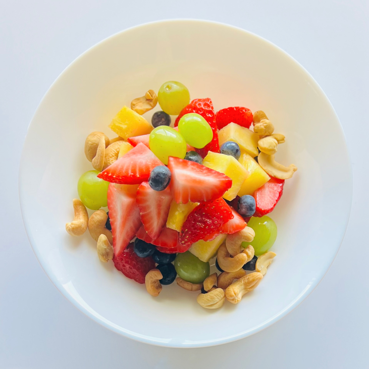 Healthy fresh fruit salad with toasted cashews