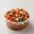 Fresh Pico de Gallo in a clear takeout sauce cup.