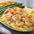 hrimp Scampi Pasta Family Bundle platter with linguine, garlic butter shrimp, and roasted asparagus