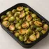 Roasted Brussels Sprouts in a black meal-prep container.