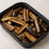 Cast Iron Eggplant Spears in a black meal-prep container.