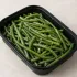 Steamed Haricot Verts in a black meal-prep container.
