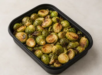 Roasted Brussels Sprouts in a black meal-prep container.