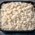 Thai Jasmine Rice sold by the ounce in a black meal-prep container.