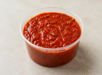 Homemade Marinara in a clear takeout sauce cup.
