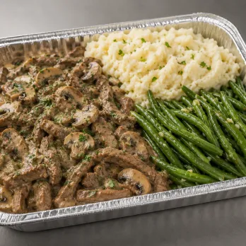 Beef Stroganoff Family Bundle in a half-size tray with creamy beef and mushrooms, mashed potatoes and green beans