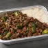 Mongolian Beef Family Bundle with glossy sauced beef, coconut rice and snap peas in a half-size aluminum tray