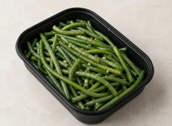 Steamed Haricot Verts in a black meal-prep container.