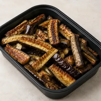Cast Iron Eggplant Spears in a black meal-prep container.