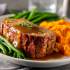 Turkey Meatloaf Family Bundle platter with turkey meatloaf, gravy, mashed sweet potatoes, and green beans
