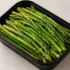Steamed Asparagus in a black meal-prep container.