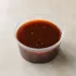 THK Mongolian Sauce in a clear takeout sauce cup.