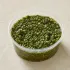 Chimichurri in a clear takeout sauce cup.