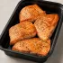 Pan Roasted Salmon in a black meal-prep container.