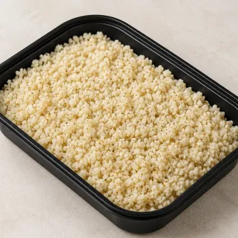 Cauliflower Rice in a black meal-prep container.