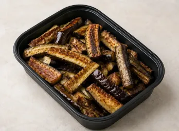Cast Iron Eggplant Spears in a black meal-prep container.