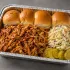 BBQ Pulled Chicken Sliders Family Bundle with saucy pulled chicken, slider rolls, coleslaw and roasted sweet potato wedges in an aluminum tray