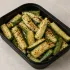 Grilled Zucchini Spears in a black meal-prep container.