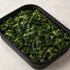 Tuscan Greens in a black meal-prep container.