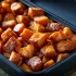 Roasted Sweet Potatoes sold by the ounce in a black meal-prep container.