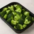 Steamed Broccoli in a black meal-prep container.