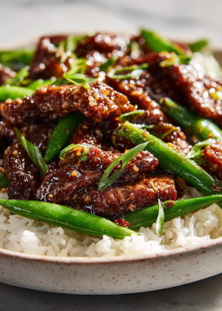 Mongolian Beef Family Bundle platter with beef, coconut rice, and snap peas
