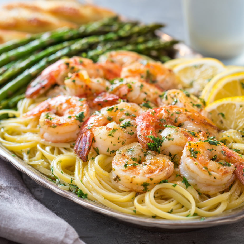hrimp Scampi Pasta Family Bundle platter with linguine, garlic butter shrimp, and roasted asparagus
