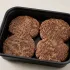 Grass-fed Beef Patties in a black meal-prep container.