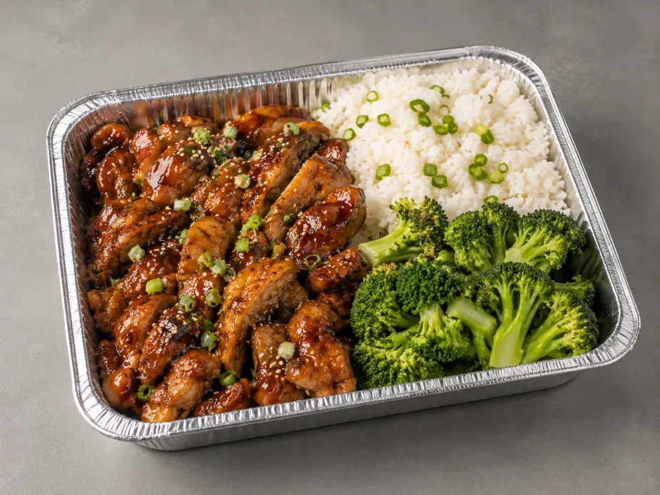 Teriyaki Chicken Family Bundle with glossy chicken, jasmine rice and broccoli in a half-size aluminum tray