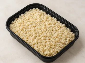 Cauliflower Rice in a black meal-prep container.