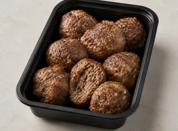 Angus Beef Meatballs in a black meal-prep container.