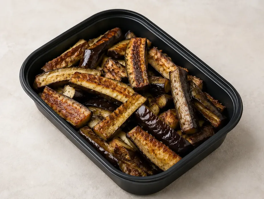 Cast Iron Eggplant Spears in a black meal-prep container.