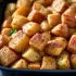 Roasted Yellow Potatoes sold by the ounce in a black meal-prep container.