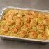 Shrimp Scampi Family Bundle with garlic-butter shrimp, thin linguine, roasted asparagus, lemon and herbs in an aluminum tray