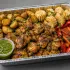 Peruvian Chicken Anticuchos Family Bundle with anticucho-style marinated chicken, roasted potatoes, corn and peppers in an aluminum tray