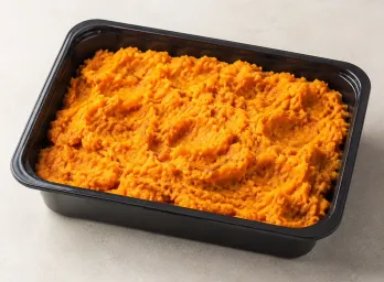 Sweet Potato Mash in a black meal-prep container.
