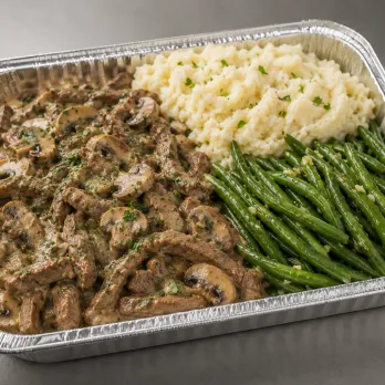 Beef Stroganoff Family Bundle in a half-size tray with creamy beef and mushrooms, mashed potatoes and green beans